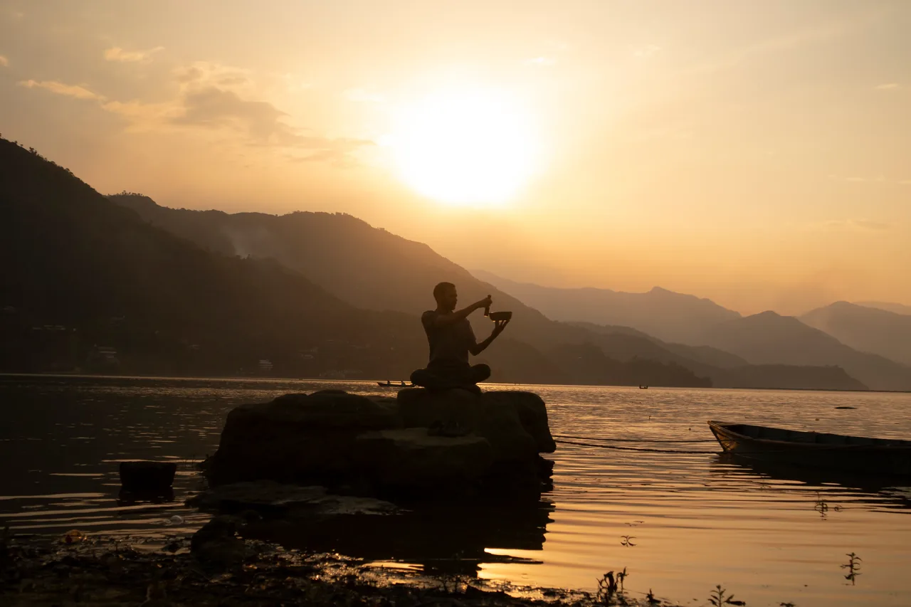 Yogi performing aarti at sunset on the sacred Ganges
